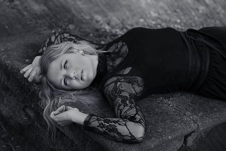 grayscale photography of woman lying on ground thumbnail