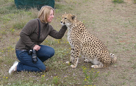 woman in grey zip-up jacket holding cheetah thumbnail