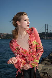 woman standing near body of water thumbnail