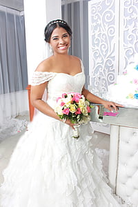 woman in white off-shoulder wedding dress holding flower bouquet thumbnail