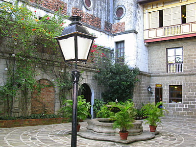 street lamp near water fountain and concrete house thumbnail