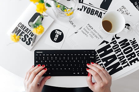 Female hands typing on the remote wireless computer keyboard thumbnail