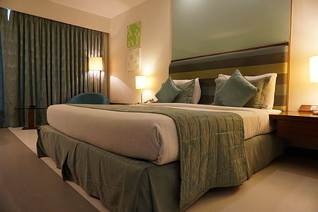 white mattress with green pillows thumbnail