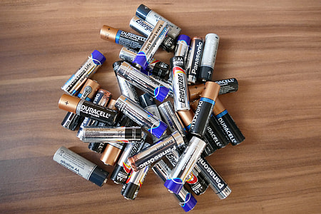 assorted-color batteries on brown wooden top thumbnail