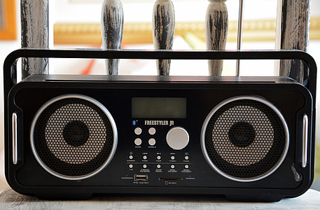 black boombox on wooden chair thumbnail