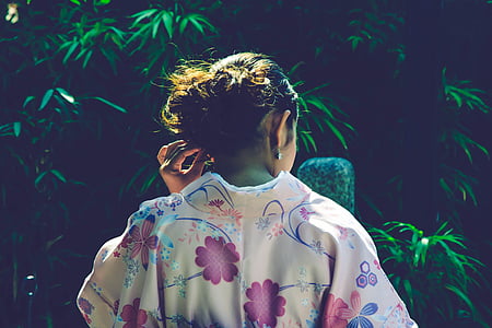 woman wearing floral top holding her ears thumbnail
