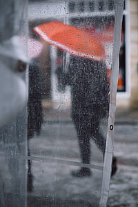 person using orange umbrella thumbnail