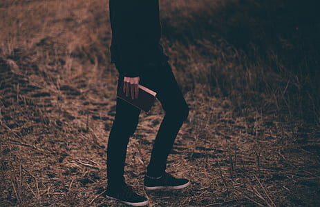 person wearing black pants standing on grass field thumbnail