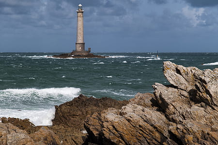 gray concrete lighthouse on island thumbnail