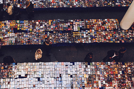 top view photo of people looking at displays on table thumbnail