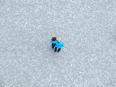 top-view photo of two man and woman standing together on road thumbnail