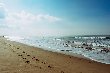ocean waves near sand at daytime thumbnail