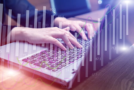 person using silver laptop with bar graph overlay thumbnail