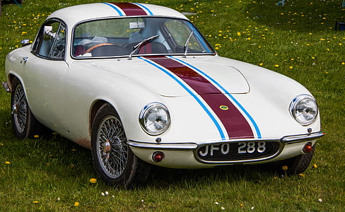 white coupe on grass field thumbnail