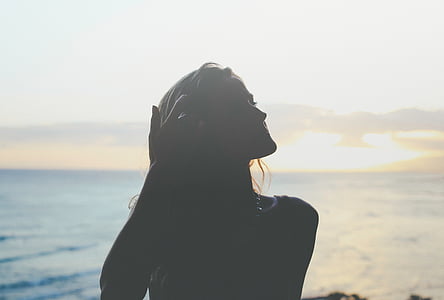 silhouette of woman near body of water thumbnail