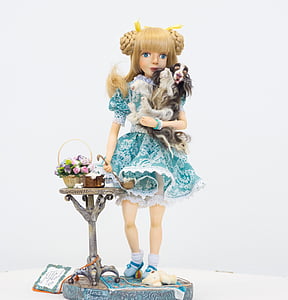 girl holding dog figurine thumbnail