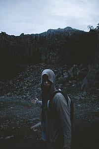 person wearing gray hoodie with backpack thumbnail