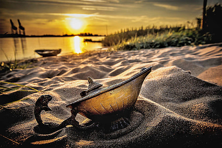 shallow focus photography of lamp on white sand during daytime thumbnail