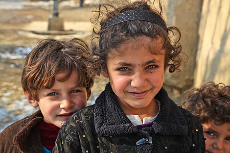 photo of three children standing near concrete wall thumbnail