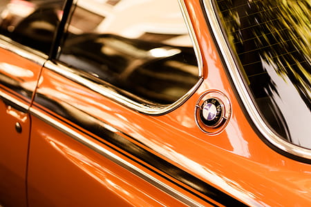 closeup photography of orange BMW coupe at daytime thumbnail