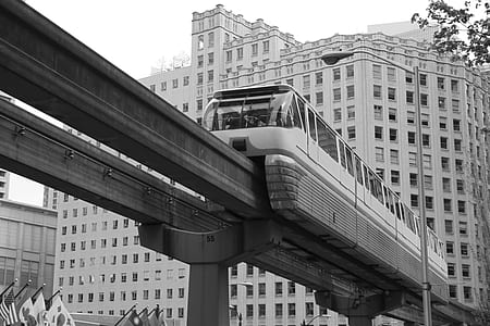 grayscale photography of train beside light post thumbnail
