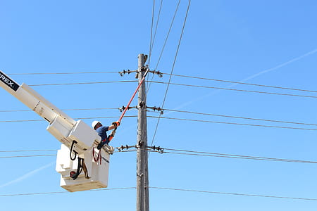 electrician on crane fixing electric post thumbnail
