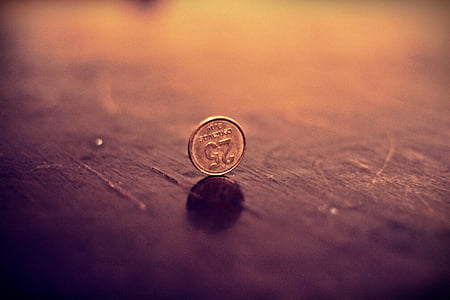 round gold-colored 25 coin on brown surface thumbnail