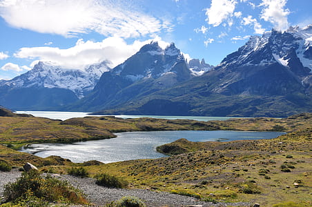 mountains and body of water under sunny sky thumbnail