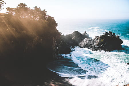 ocean waves beside rock formation thumbnail