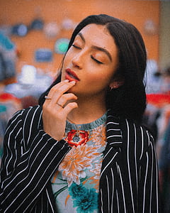 shallow focus photography of woman touching her lips thumbnail