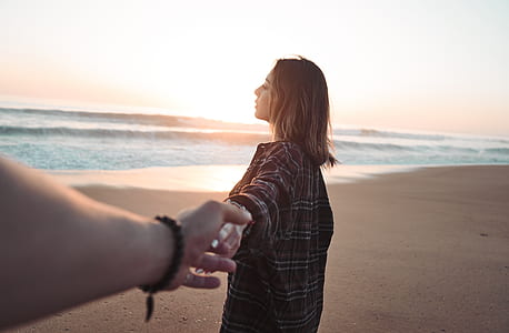 woman holding hands on seashore thumbnail
