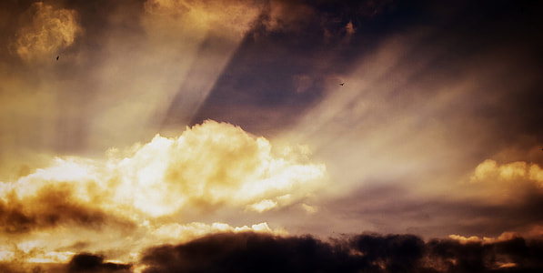 sun light piercing through brown clouds thumbnail