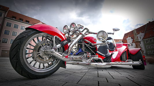 red and silver tricycle during daytime thumbnail