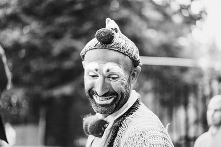 grayscale photography of man in clown costume smiling thumbnail