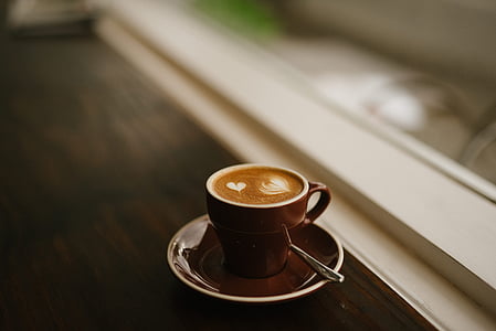 brown ceramic coffee mug on saucer thumbnail