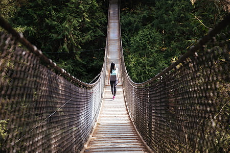 Woman Walks Bridge Photo thumbnail