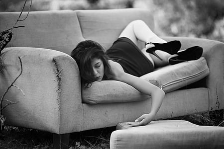 woman in black dress lying on sofa thumbnail