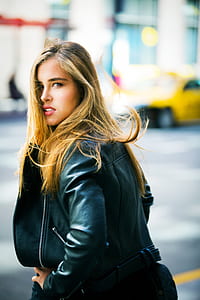 Woman Wearing Black Leather Jacket Facing Backward thumbnail