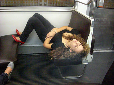 woman lying on train seat thumbnail
