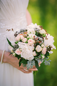 bride holding bouquet of white flowers thumbnail