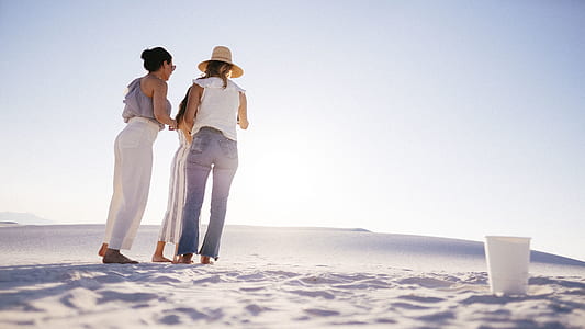 three women standing on desert near polypyrene cup at daytime thumbnail