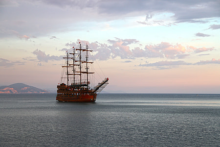brown sailing ship with body of water photography during day time thumbnail