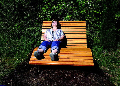 woman lying on wooden lounger bench thumbnail