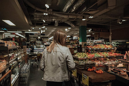 woman standing in front of produce stand thumbnail
