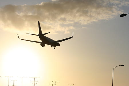 silhouette photo of flying airliner thumbnail