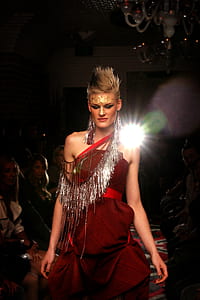 model walking on stage wearing red tube-top dress thumbnail