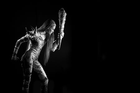 grayscale photography of woman holding tube thumbnail
