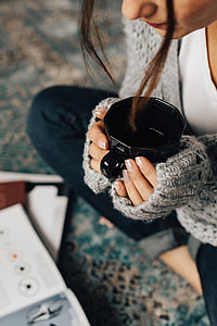 Woman reading magazines on the floor while enjoying her cup of tea thumbnail