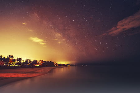 coastline under grey and black starry skies thumbnail
