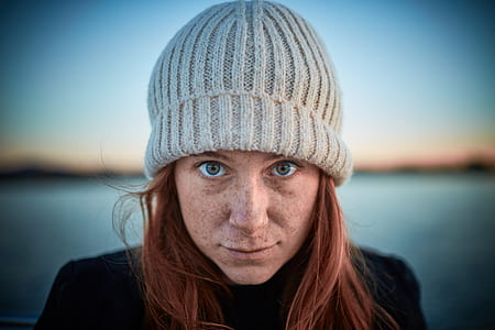 woman wearing gray knit cap while taking selfie thumbnail